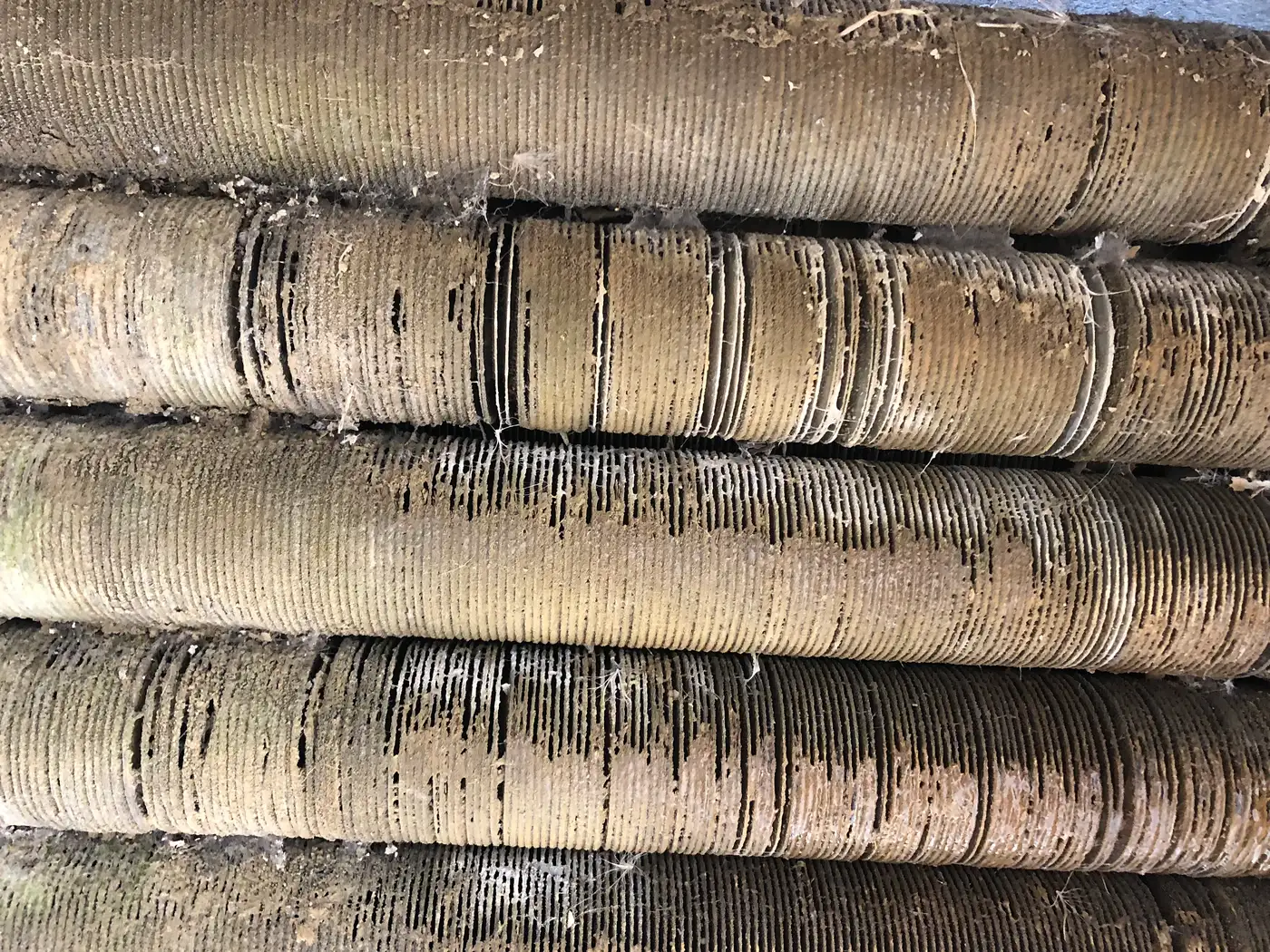 Finned tubes covered in scale and mineral deposits